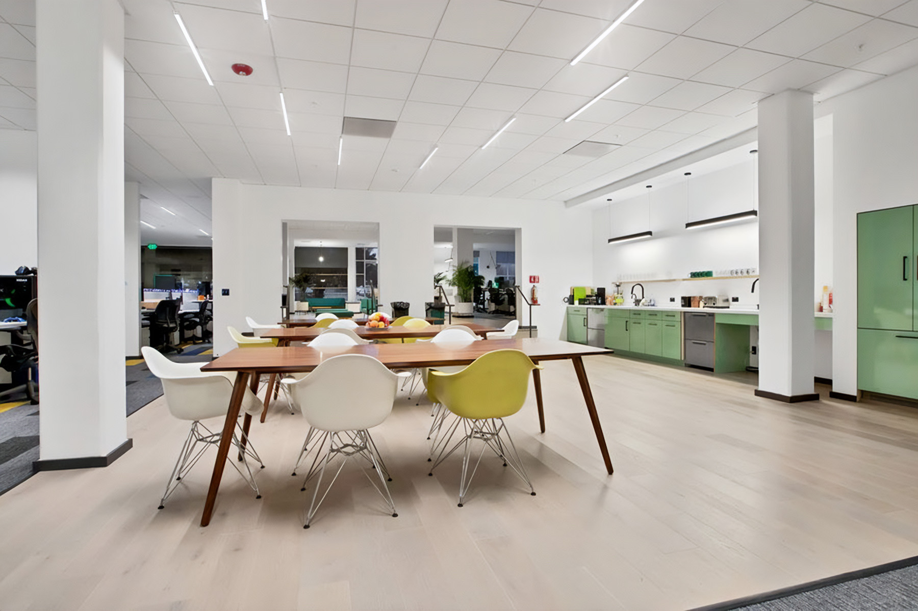 Tunable-white linear suspension light fixtures in common spaces also allow occupants in spaces like kitchen areas to create a more relaxing environment