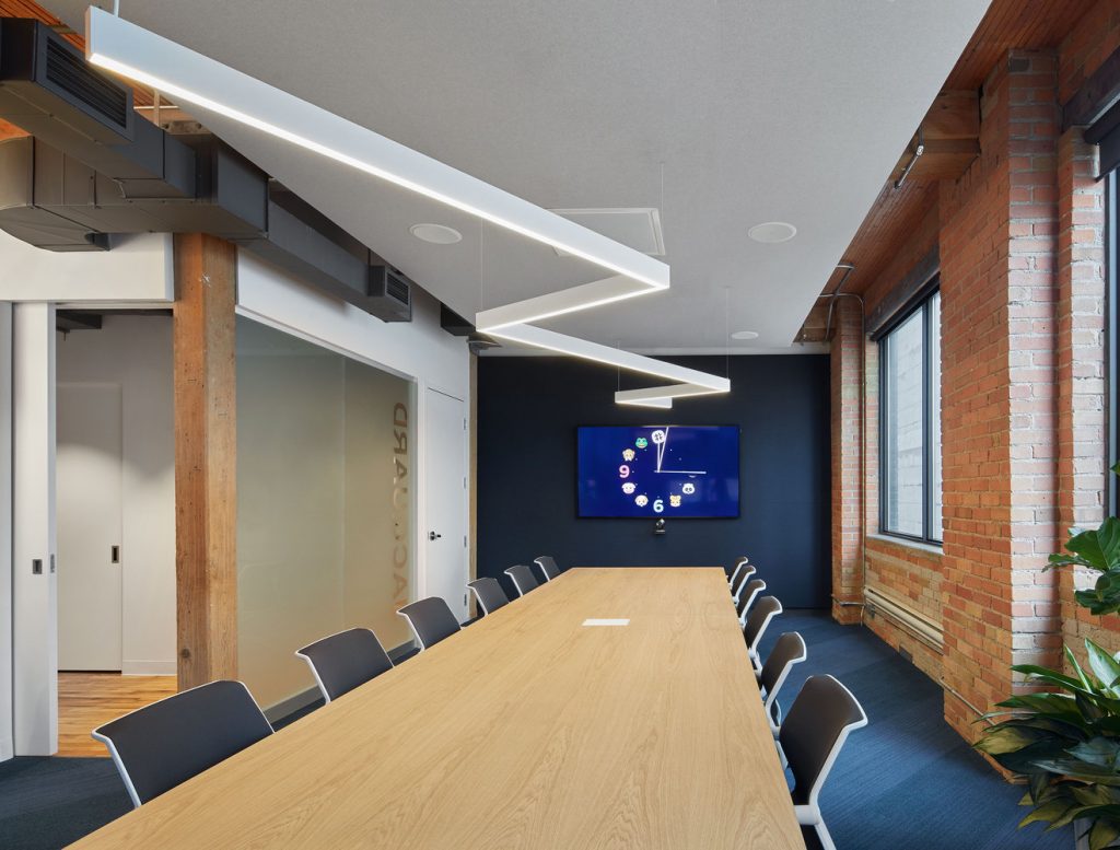Angled connections allow designers to link LED suspension lights together in original patterns, such as a zig-zag pattern running the length of an office conference room table