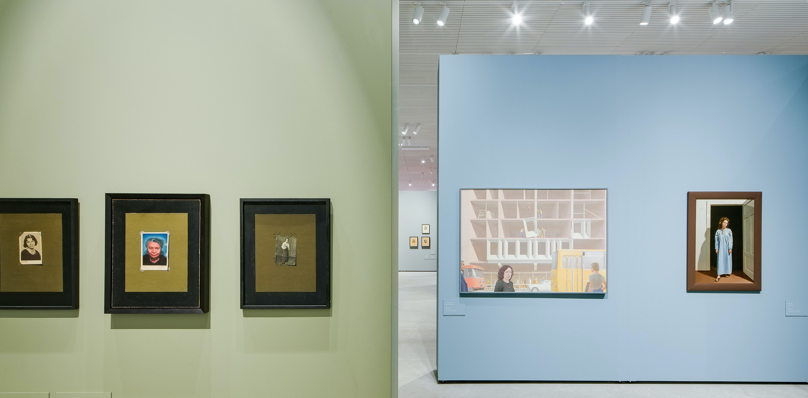 Track lights offer the benefit of directional art lighting in this gallery to properly light each painting