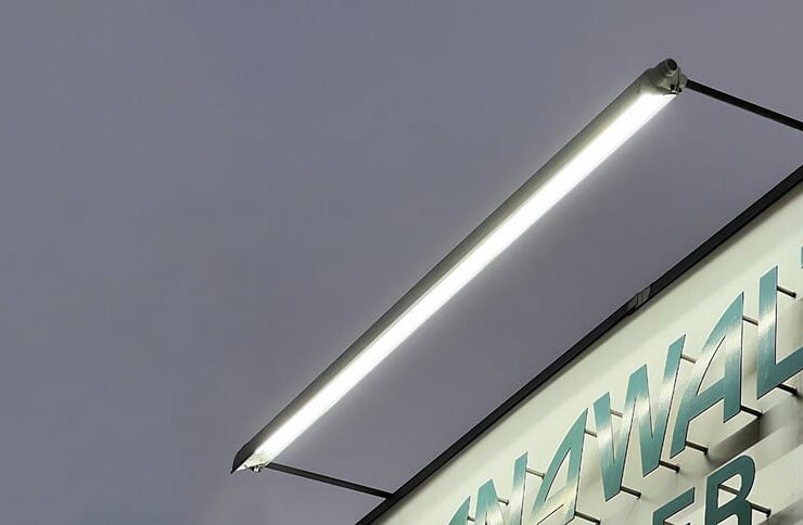 Sign lighting where the light fixture is mounted above the business signage