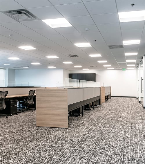 Center-basket LED troffer lights by Alcon Lighting illuminate
workspaces in an open floor plan office area of the Tabor Center in Denver,
Colorado