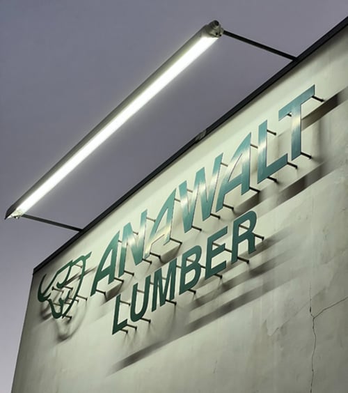 A wet-location-rated rotatable LED sign light illuminates Anawalt Lumber’s sign for the business’ 100-year-old original storefront in Los Angeles, California.