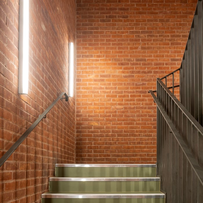 Vertical LED linear wall lights improve safety by illuminating a stairwell