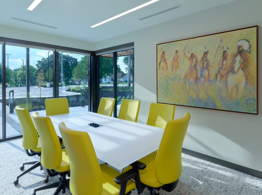 Bright yellow ergonomic chairs and colorful Native American artwork bring bold colors to a conference room with this architectural trend