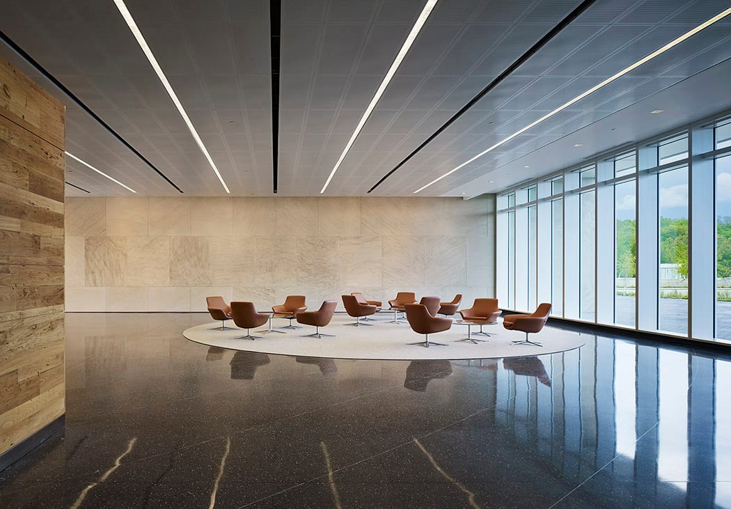 Noonday sun streaming through commercial lobby with linear recessed lighting