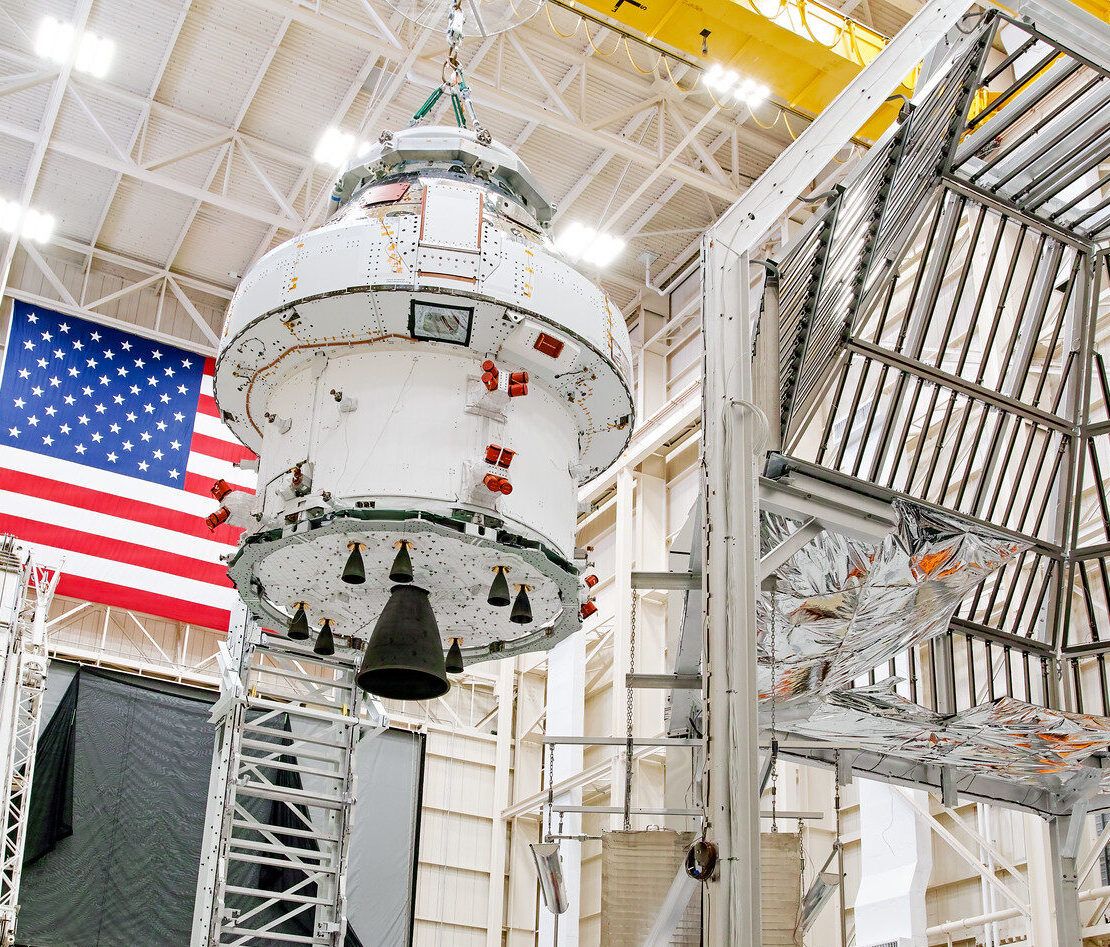 Engineers prepare the Artemis space capsule for thermal testing at NASA's Plum Brook Station