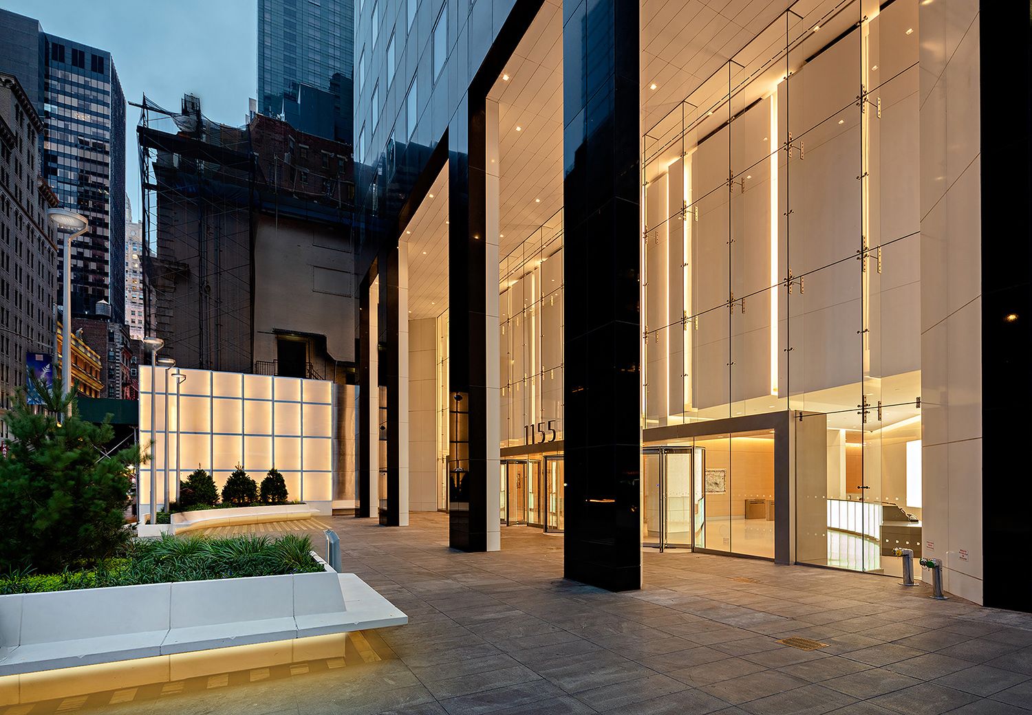 POPS plaza at 1155 Avenue of the Americas illuminated at dusk.