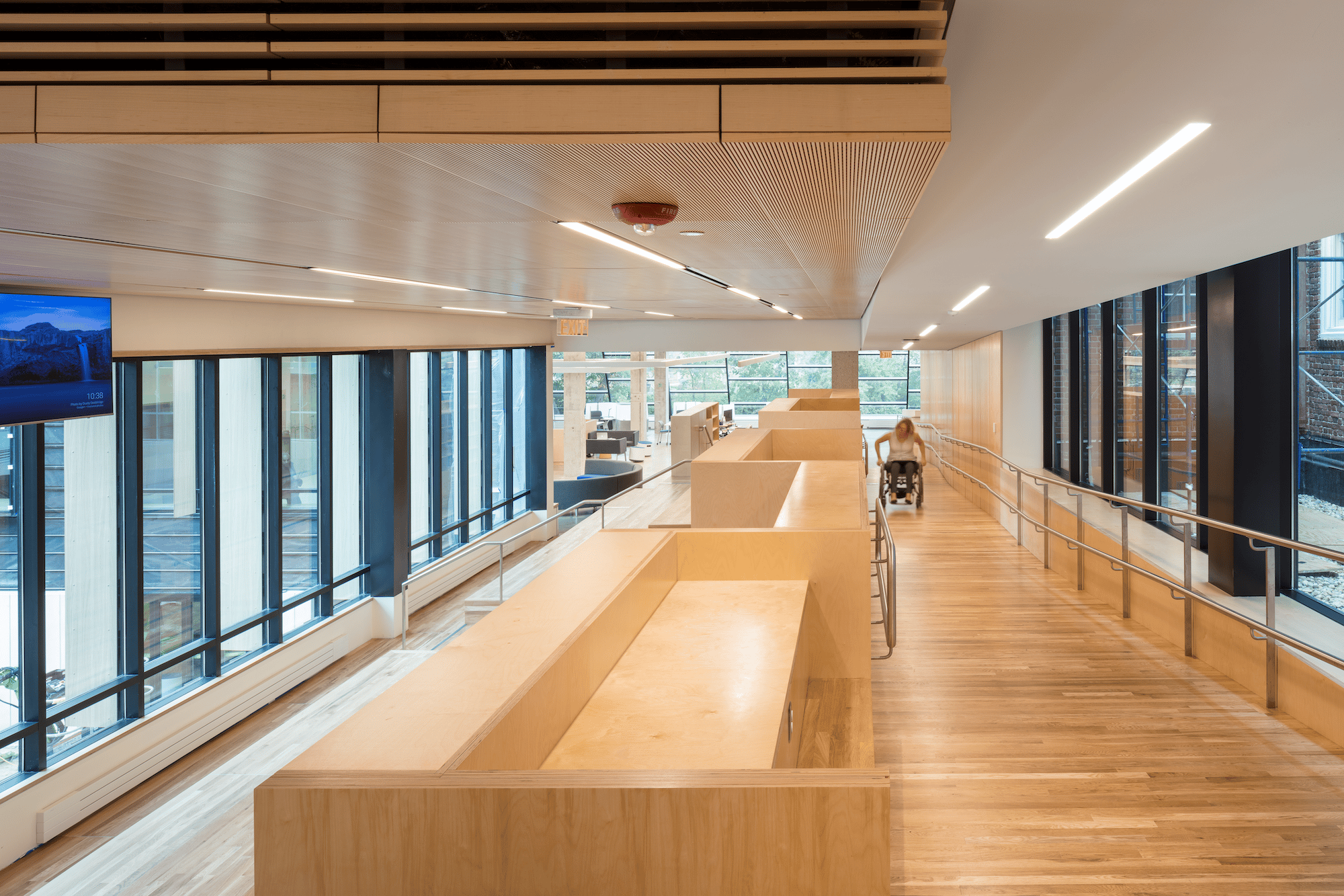 A corporate office building features emergency exit lighting on a wheelchair-accessible exit path.