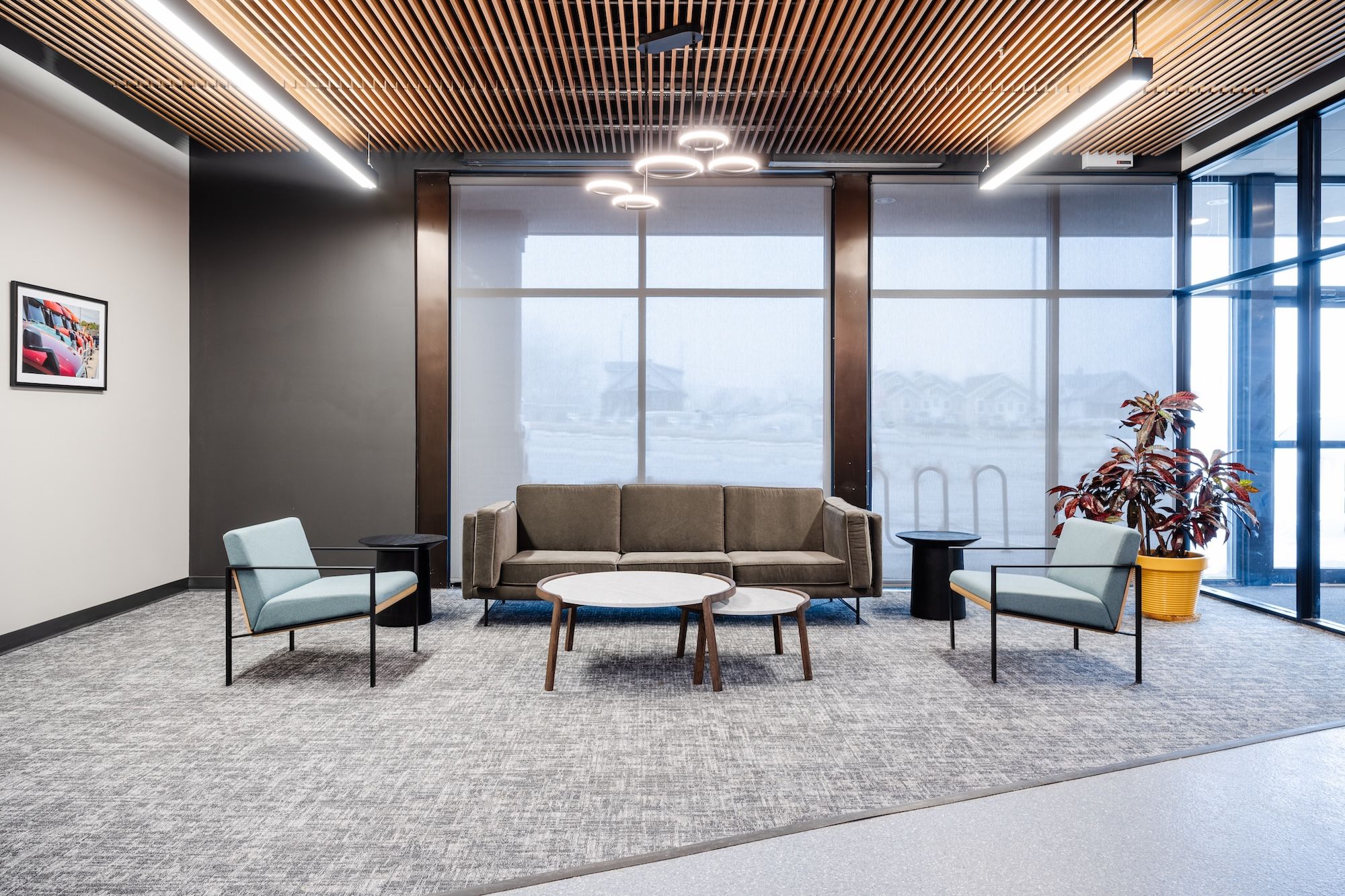 A wood slatted ceiling and carpeted cutout create a sense of home in the welcome area.