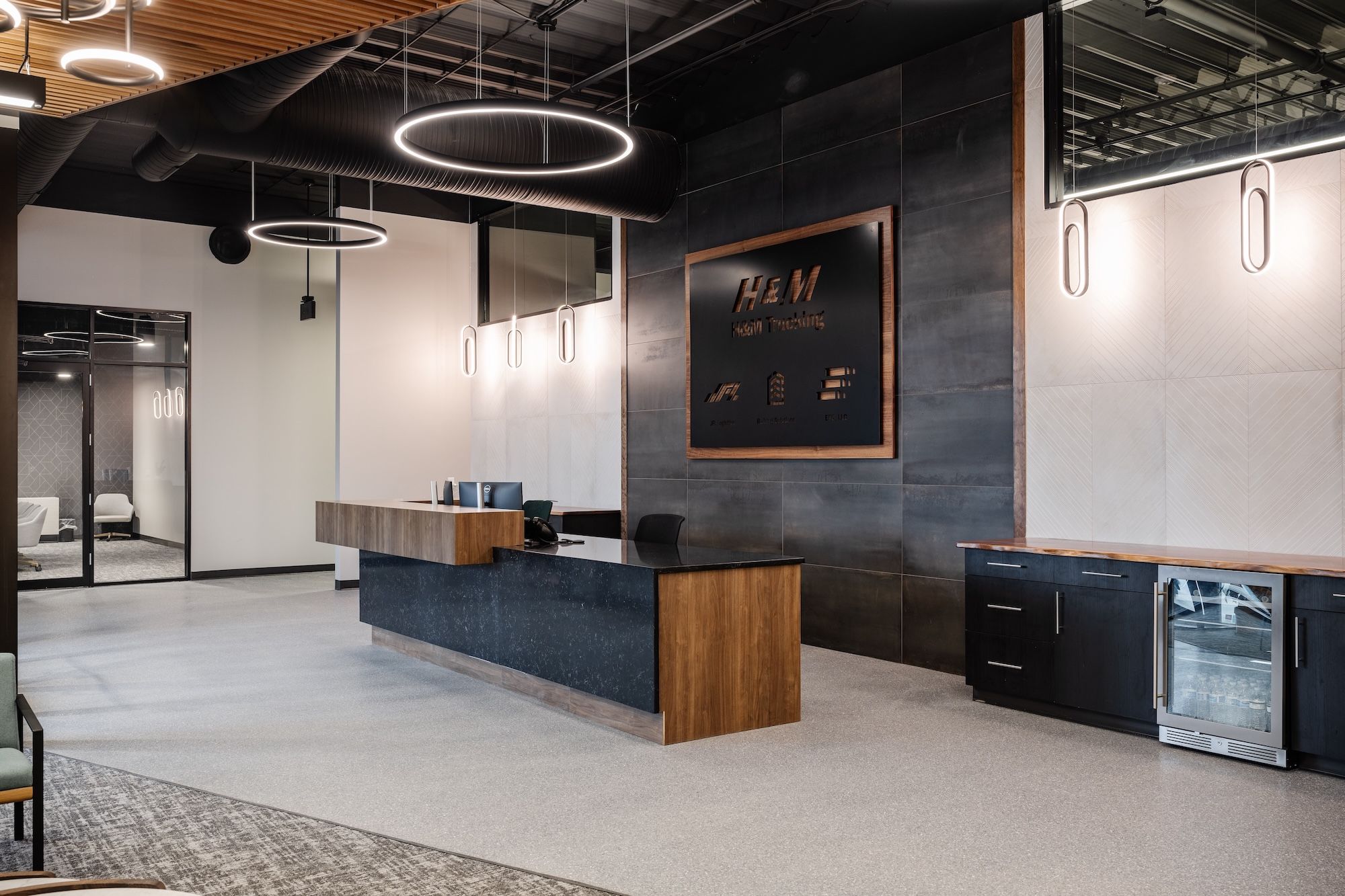 Materials such as natural stone and wood add a warmer, more natural feel to the warehouse offices.