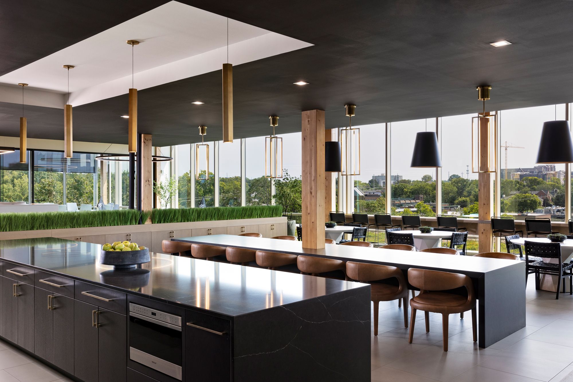 A vaulted ceiling with elegant gold pendants offers a high-end restaurant feel in Elmington's employee kitchen area.