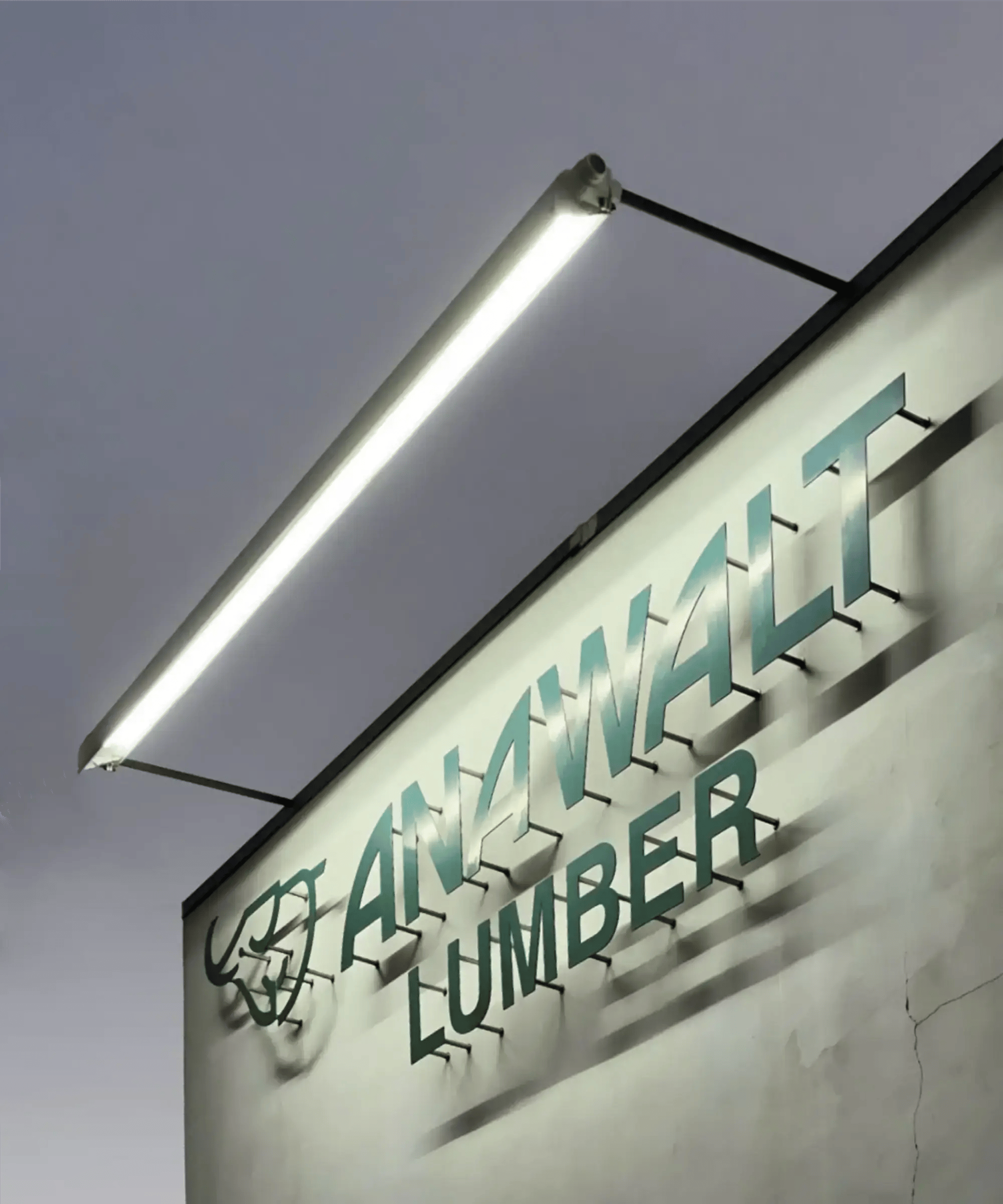 The 31029 exterior commercial LED sign light illuminates Anawalt Lumber's signage on the building's front facade.