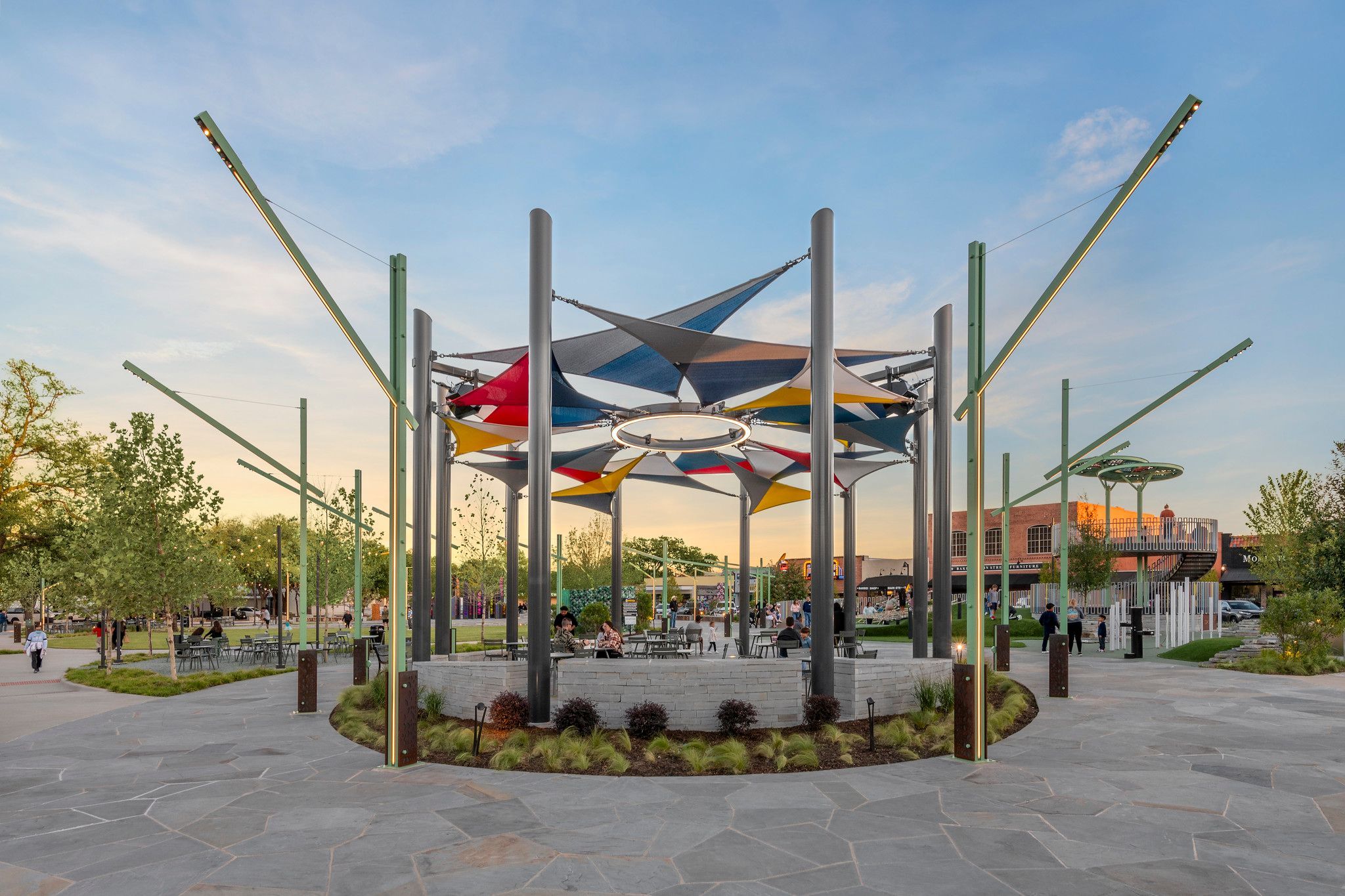 RGBW linear LEDs light decorative posts in a downtown plaza with a ring light suspended in an art installation.