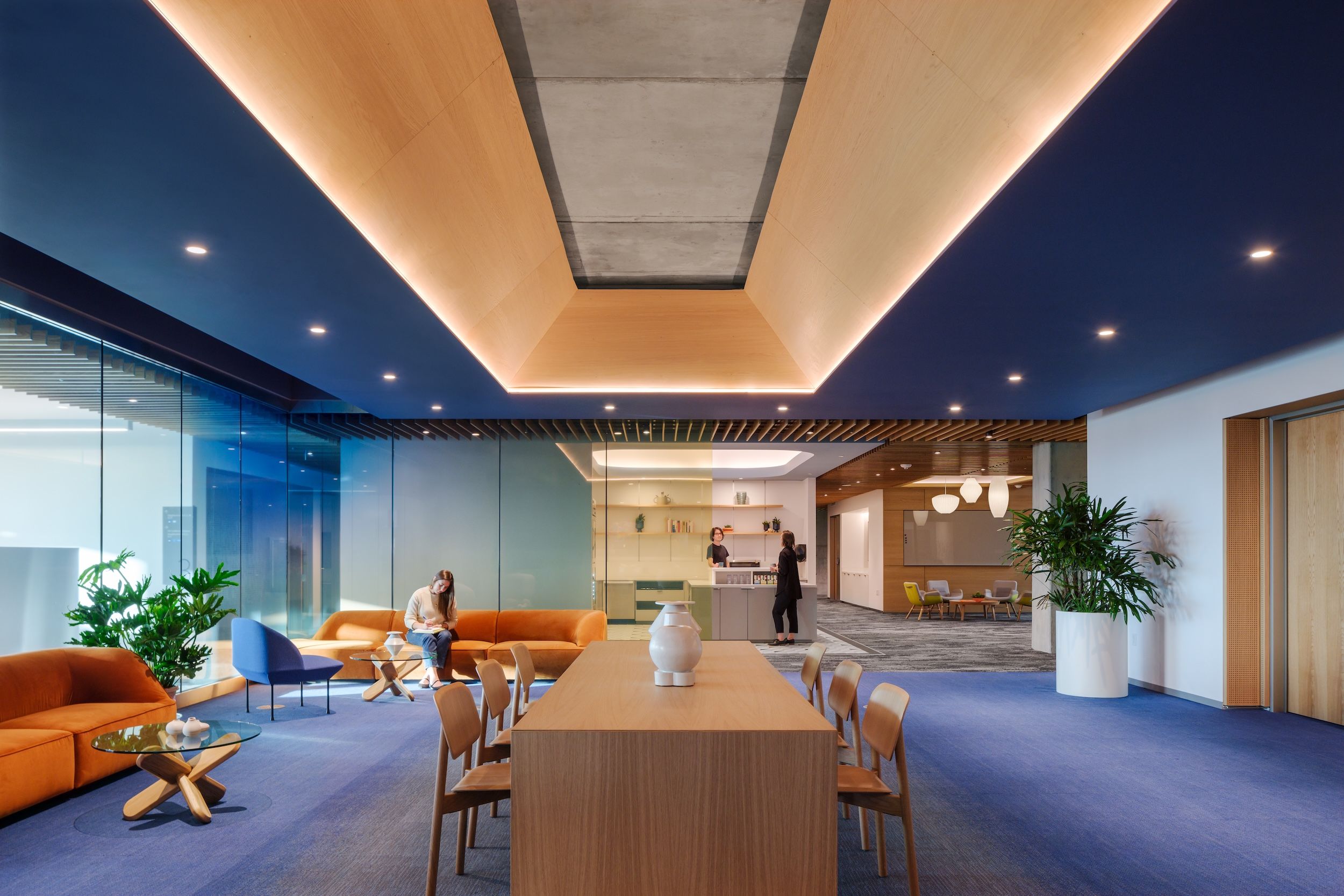 Cove lighting provides indirect uplighting in a beveled inverted tray in a coffered ceiling.