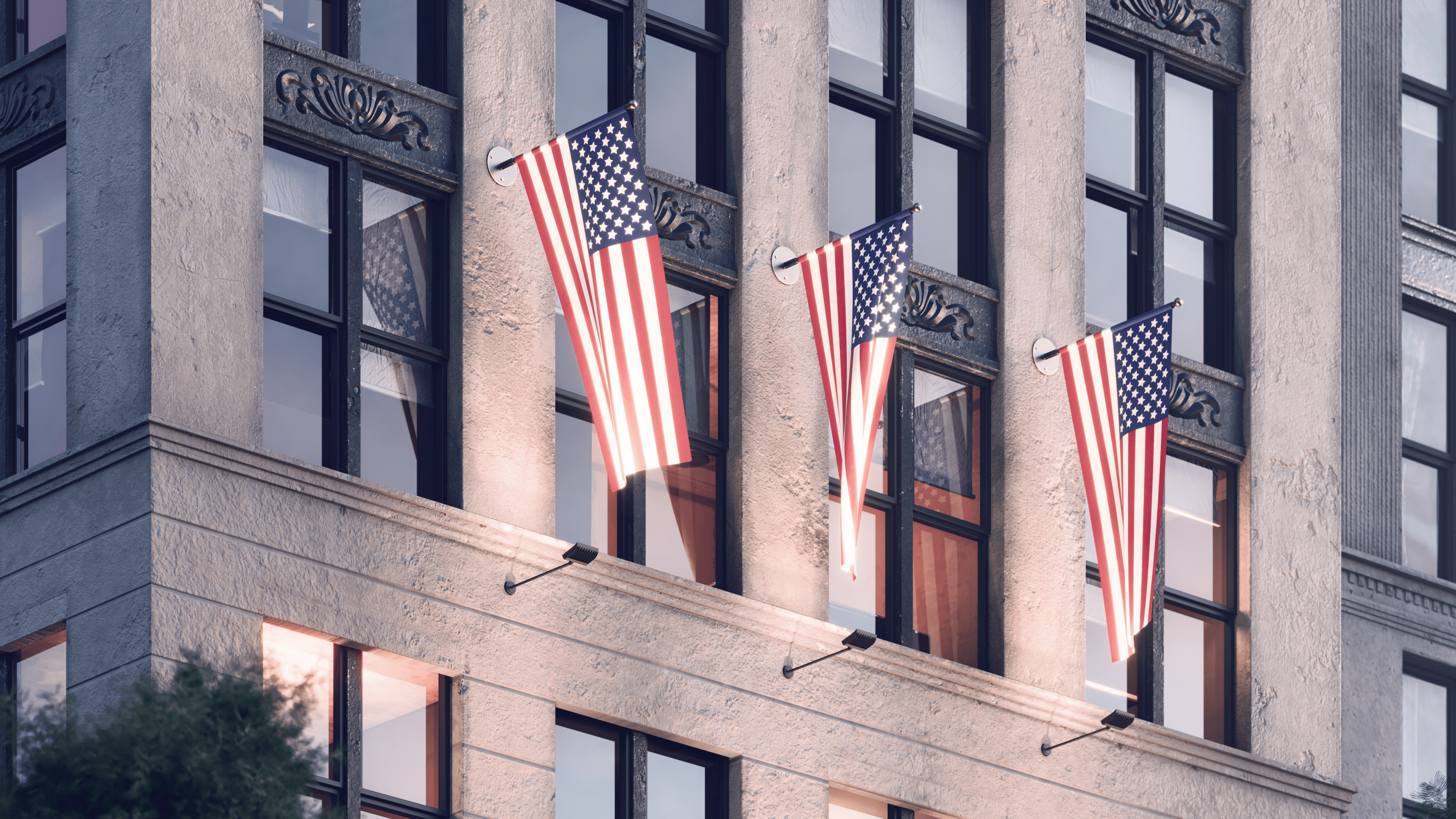 Alcon 31033 LED flag sign lights mounted on building façade illuminating multiple American flags at night.