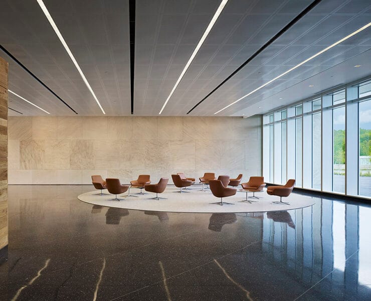 Noonday sun streaming through commercial lobby with linear recessed lighting