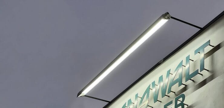 Sign lighting where the light fixture is mounted above the business signage