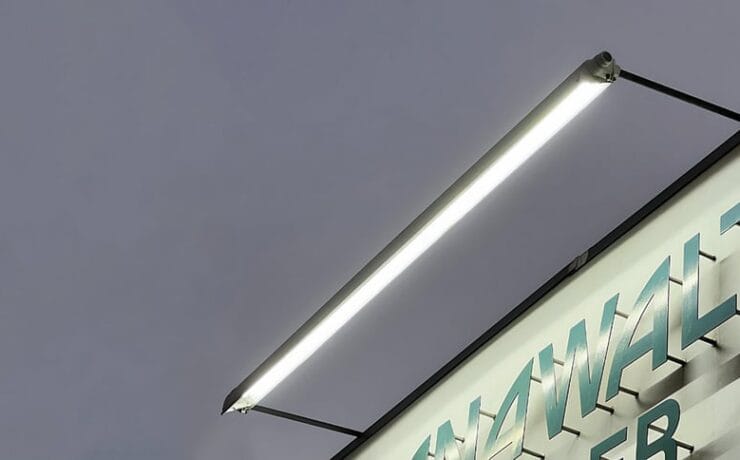 Sign lighting where the light fixture is mounted above the business signage