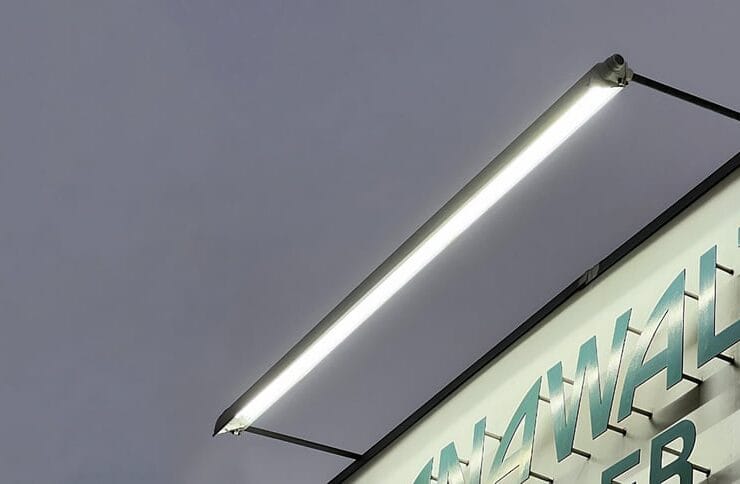 Sign lighting where the light fixture is mounted above the business signage
