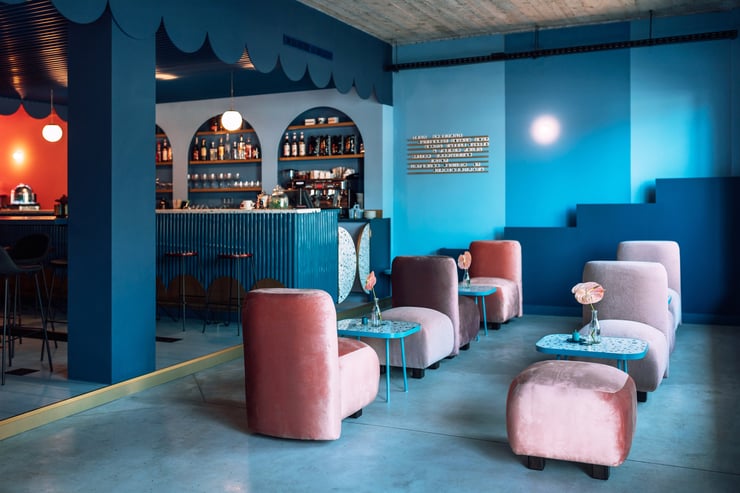 in the intro to lighting design, we explain how designers balance natural and electrical light, as seen in this cafe