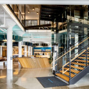 You can find several architectural trends for 2023 featured in the Plant Seven coworking space in Highpoint, North Carolina, including rounded pendants, bold pops of color, natural wood finishes, and homey plaid-patterned chairs