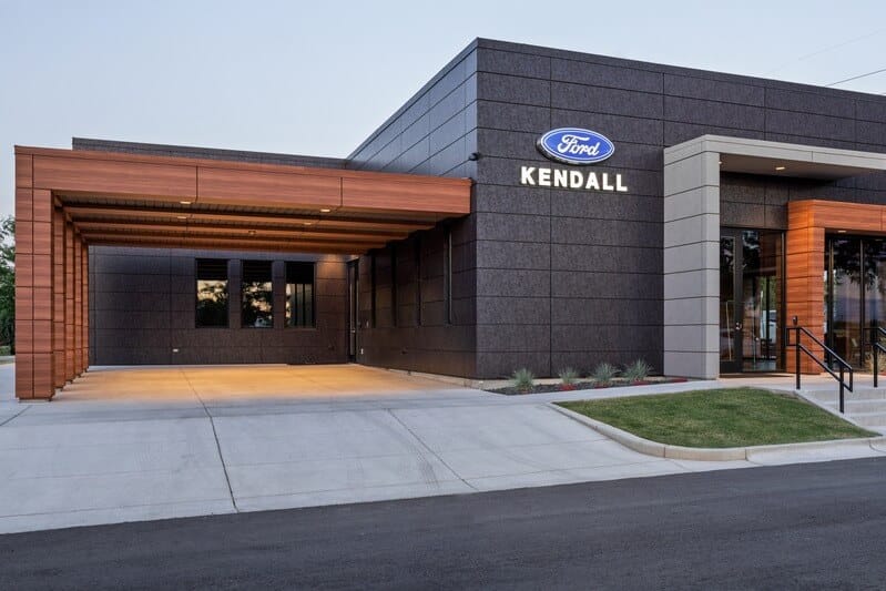 Round recessed LED downlights rated for wet locations illuminate the carport and pedestrian entrances of the Kendall Ford Bronco dealership.