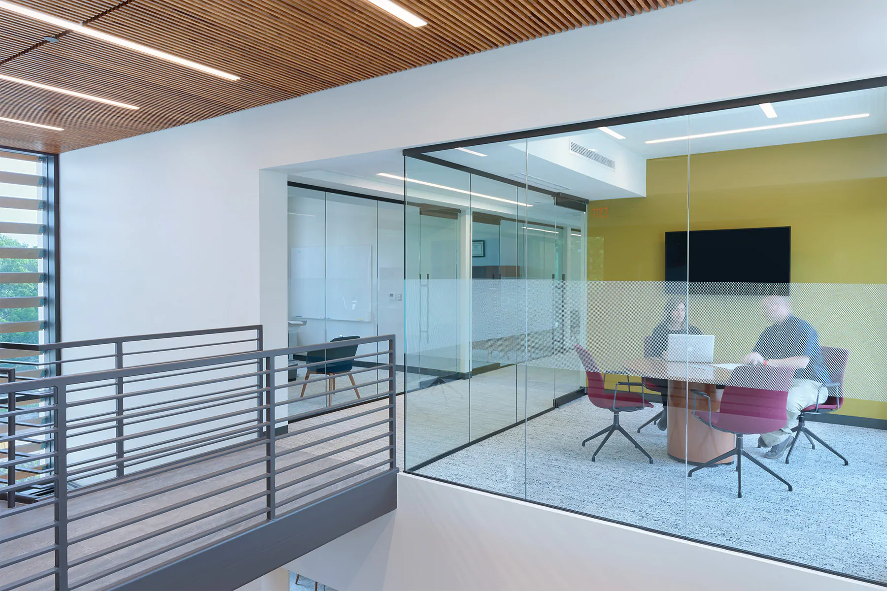 Trimless recessed linear lights illuminate conference rooms and corridors at a law office.