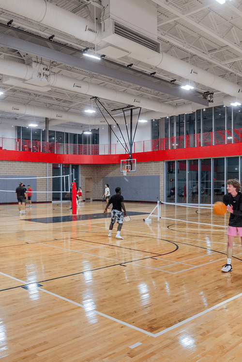 LED high bay lighting provides broad, even illumination across an indoor basketball court and gymnasium.