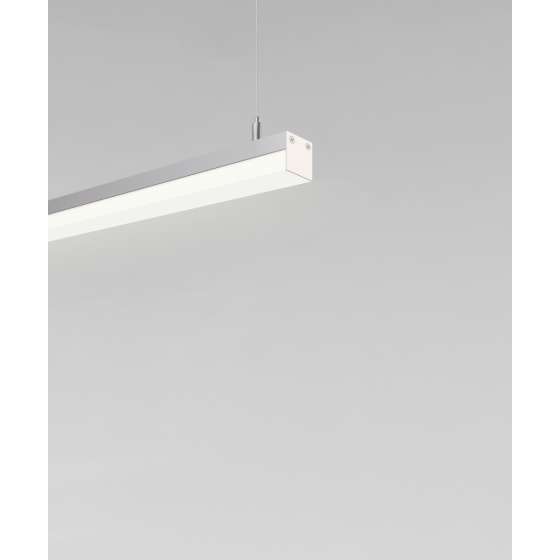 suspended pendant light shown with silver finish and side-wrapping lens