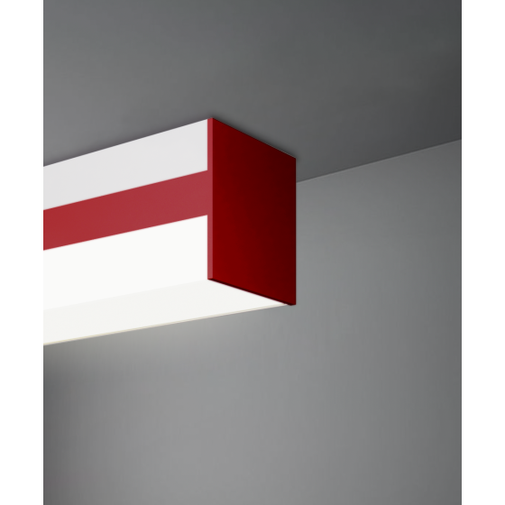 Alcon 12100-3-S, surface linear ceiling light shown in red finish and with a flush wrapping trim-less lens.