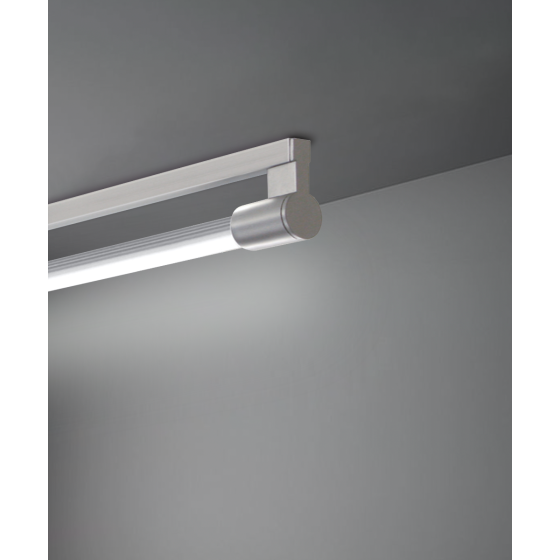 Alcon 12160-S, surface linear ceiling light shown in silver finish and with a tubular half-lit trim-less lens.