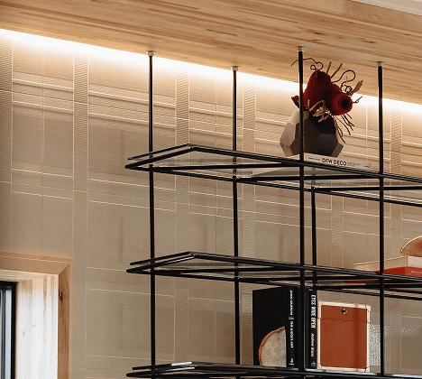 LED perimeter wall wash cove lighting highlights embossed wallpaper texture behind a suspended glass bookshelf
