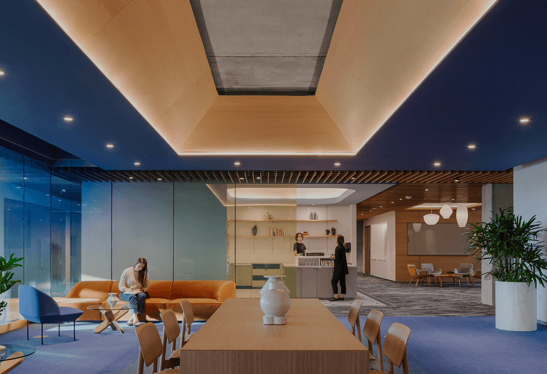 Continuous-run LED cove lighting provides layered indirect illumination in a corporate interior at Intuit’s headquarters.