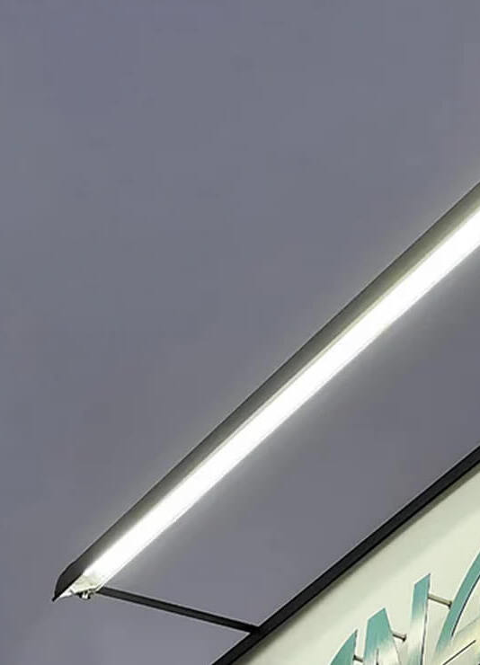 Wet-location-rated adjustable LED sign lighting illuminates the Anawalt Lumber storefront sign in Los Angeles, California.