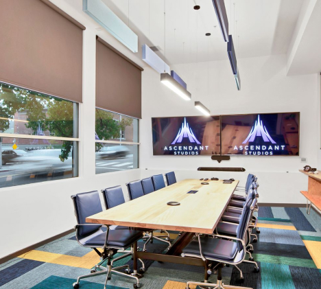 Tunable white linear pendants allow lighting to be tuned over a conference room table in a video game development studio.