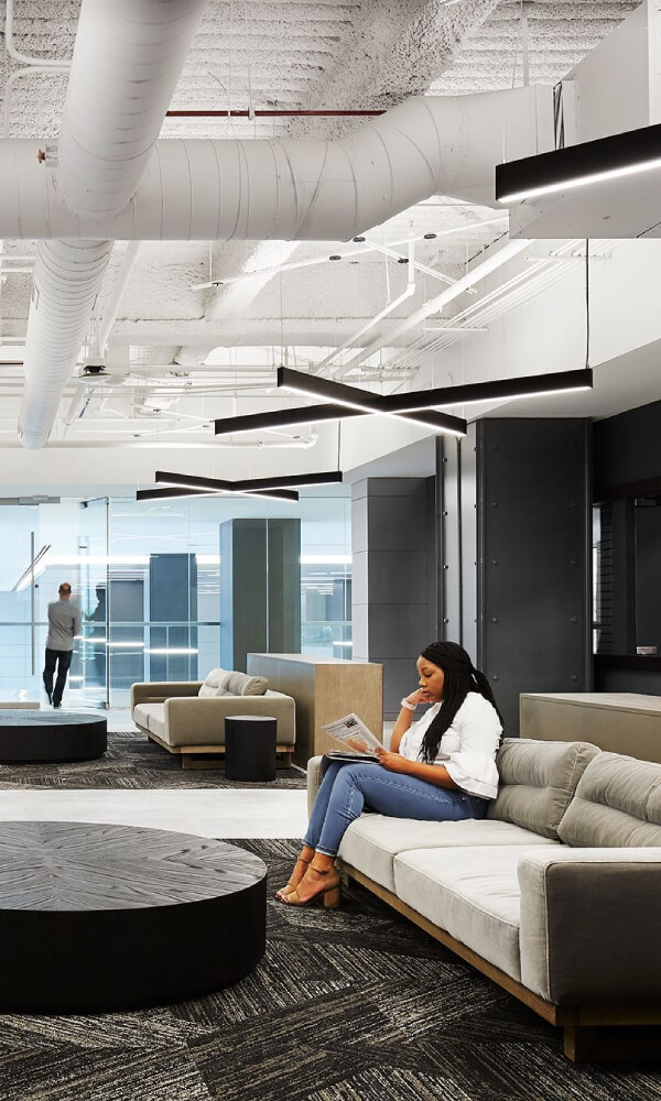 X-shaped pendant lights provide direct/indirect illumination to improve visual comfort in a lobby.