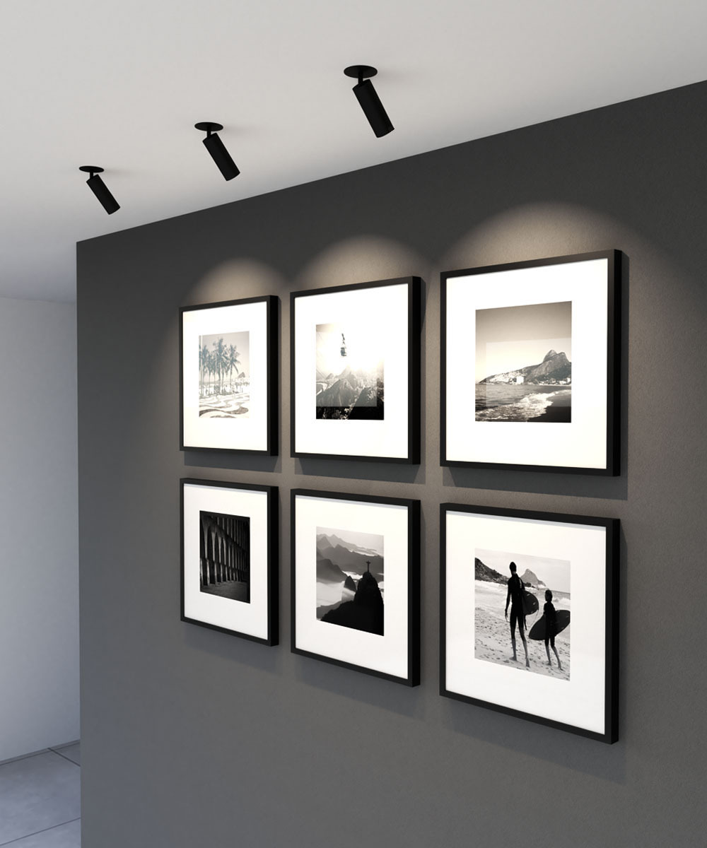 White monopoint lights illuminate products and wall art in a nail salon.