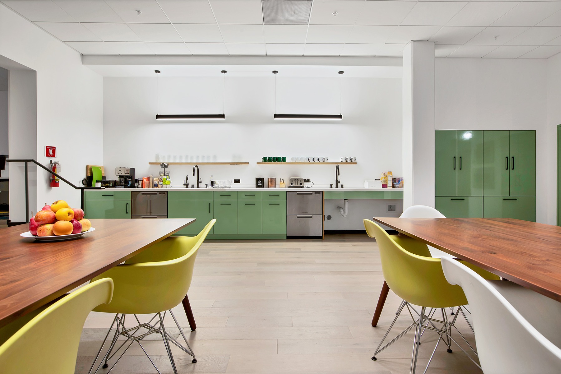 Tunable-white linear suspension light fixtures in common spaces also allow occupants in spaces like kitchen areas to create a more relaxing environment