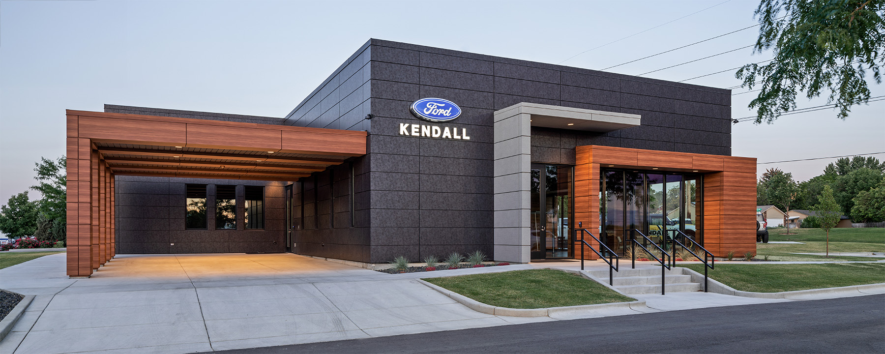 Recessed can lights illuminate the entrance and porte cochere of the Kendall Ford Bronco car dealership.