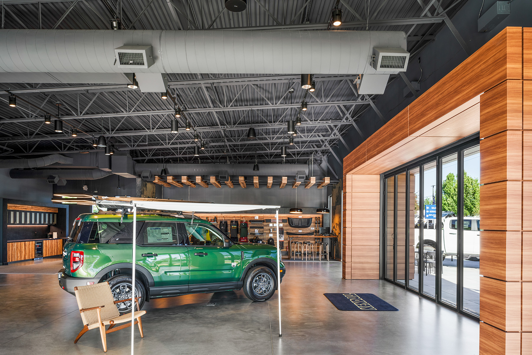 ZGA Architects used lighting to create distinct areas and functional zones within the open floorplan car dealership showroom.