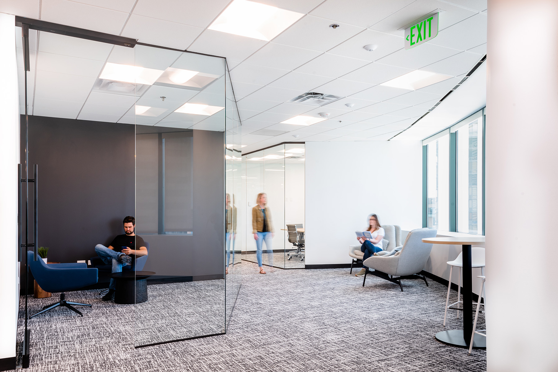 Square troffer ceiling light fixtures in offices and hallways at the Tabor Center provide ample light while balancing against the natural light that comes through the space’s large windows.
