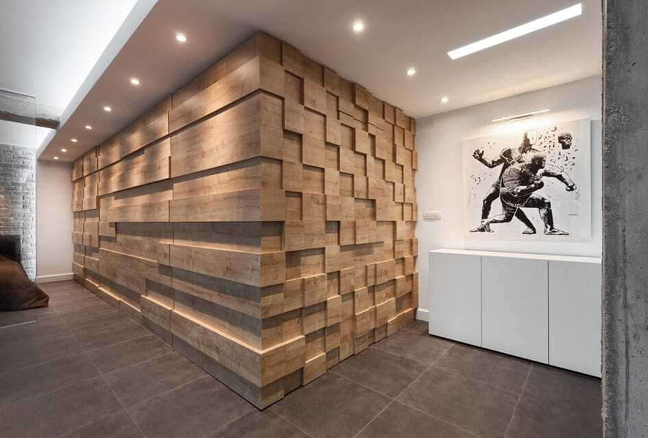 Can lights illuminate an architectural wood wall feature in a home with a linear recessed light providing art lighting.