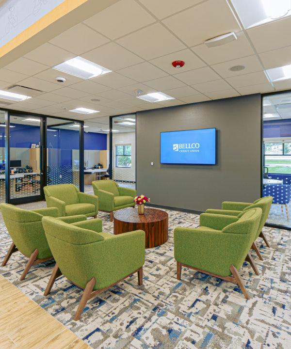 Indirect center-basket LED troffer lights provide general lighting over the credit union waiting area with minimal glare.