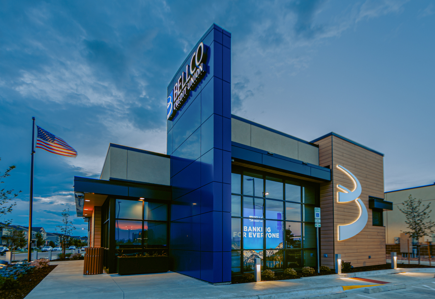 Exterior LED lighting at the Bellco Credit Union includes round recessed downlights on the soffit and LED bollards.