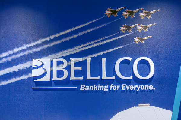 Closeup of a Bellco Credit Union logo display with their slogan: Banking for Everyone.