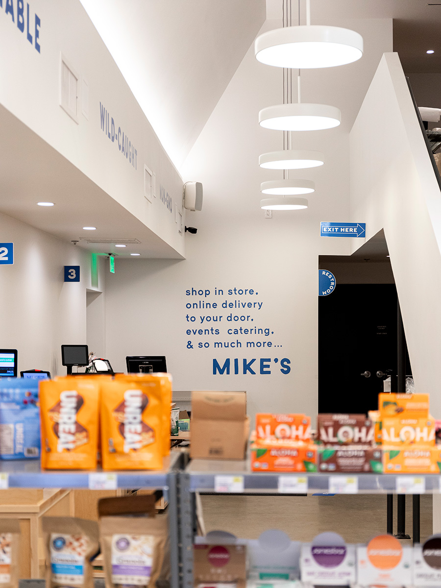 Openshop used Alcon Lighting recessed can lights and disk lights to light products with cove lighting to accent the architectural ceiling structure