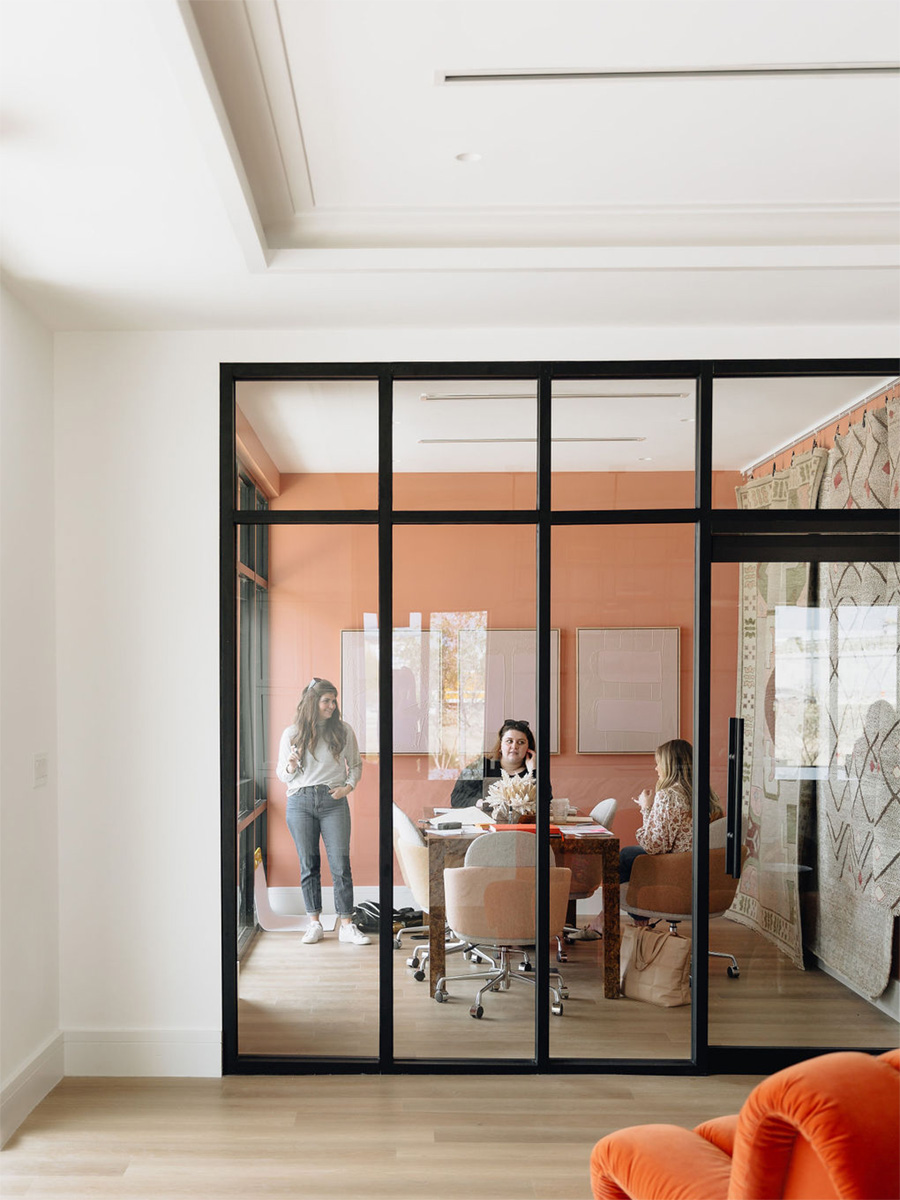 Lighting in the HBHQ podcast studio office conference room balances with natural light from the large windows