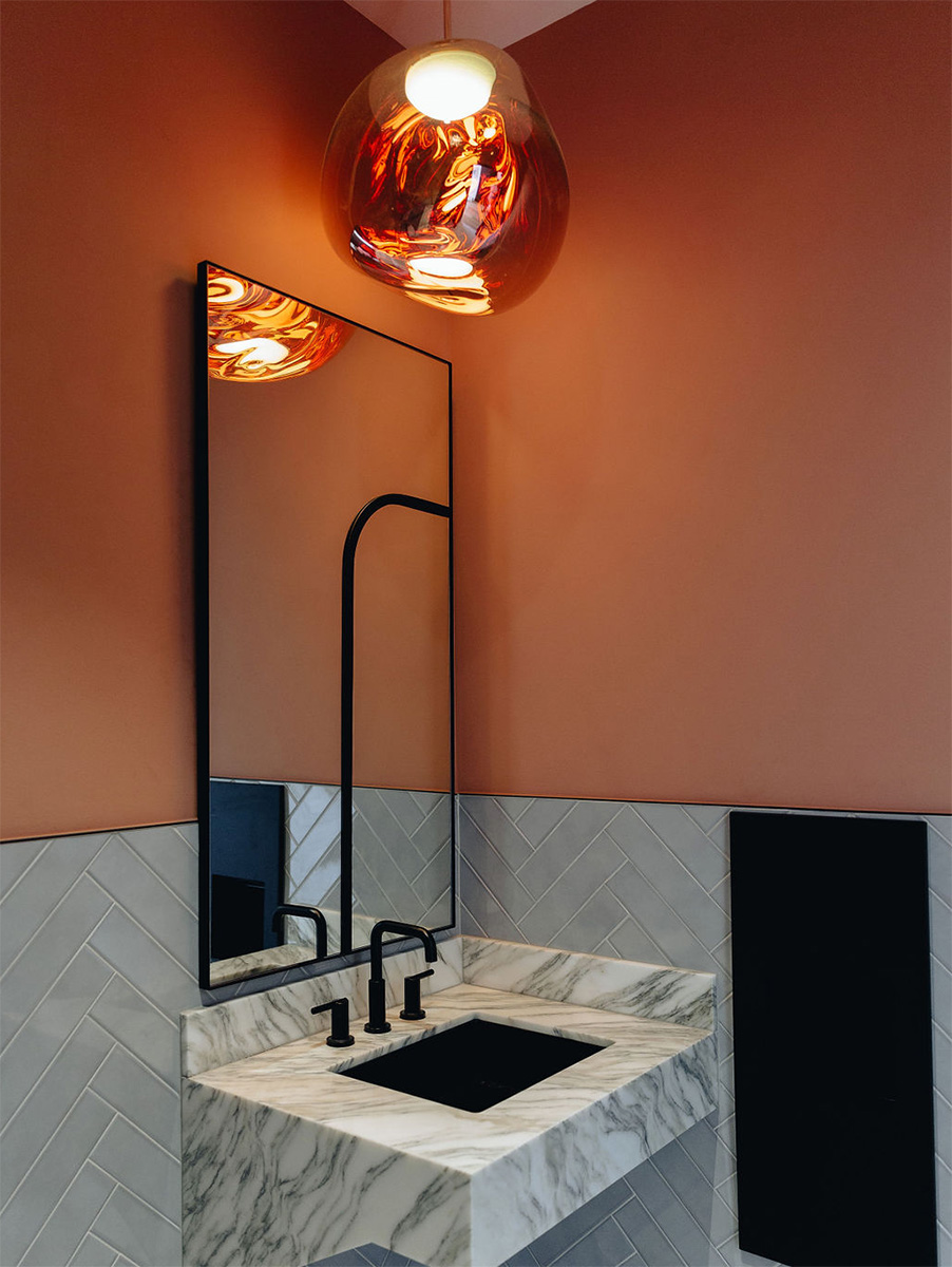 Commercial bathroom lighting at HBHQ in Fort Worth, Texas, features a modern decorative pendant light