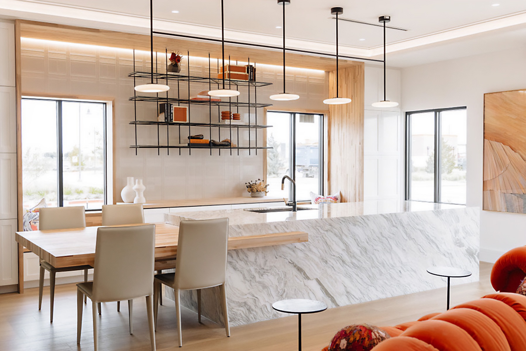 A 5-light pendant light hangs over the HBHQ office kitchen island, providing task lighting, with linear recessed and round recessed lights affording general lighting