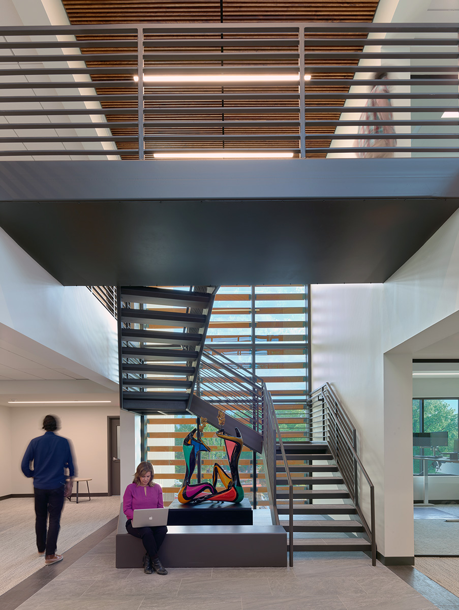 Linear recessed lighting in the corridors and stairwell aids in creating flexible working and social spaces in the Sharp Law Office.